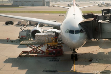 Loading cargo on plane in airport before flight.